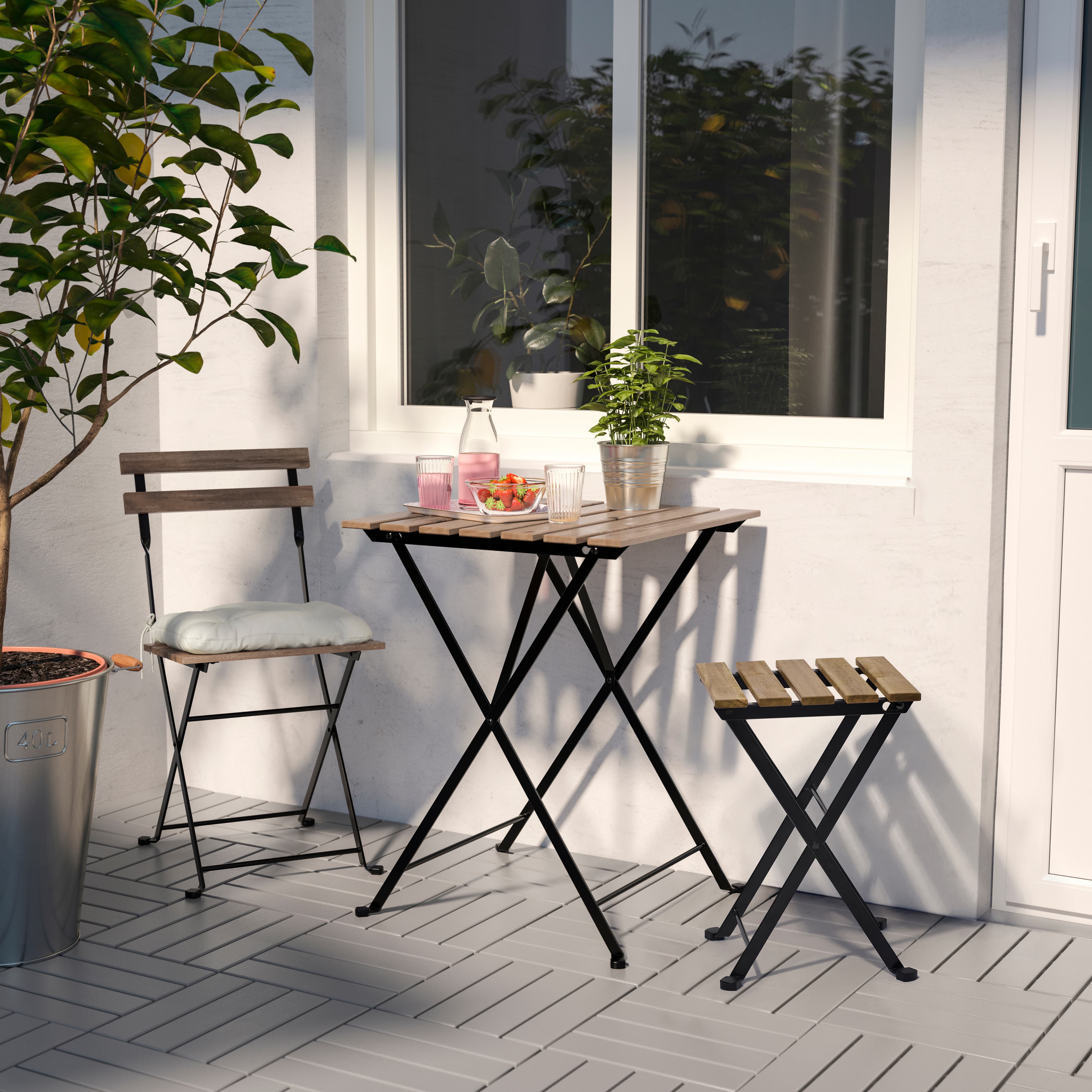 An outdoor table and two chairs