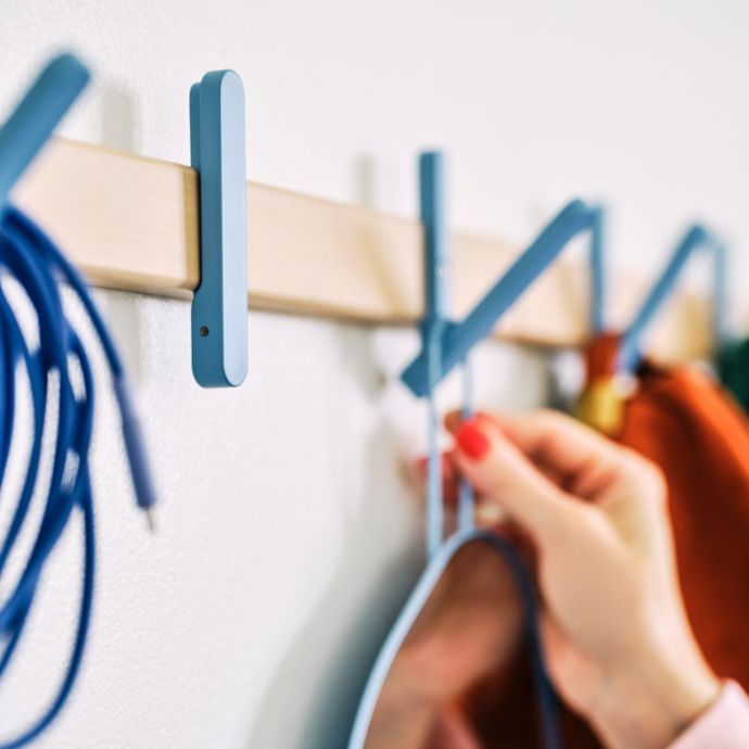 Organized entryway with IKEA PS 2026 wall hooks, offering practical storage and a colorful modern accent.