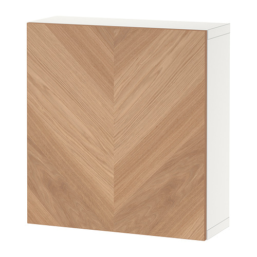 Exhibe un mueble de almacenamiento BESTÅ, con marco blanco y puerta de madera con patrón de nido de abeja.
