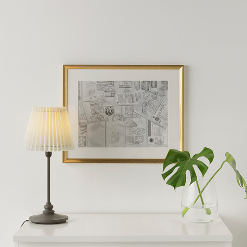 Espacio habitable minimalista con collage de sellos, lámpara y planta.