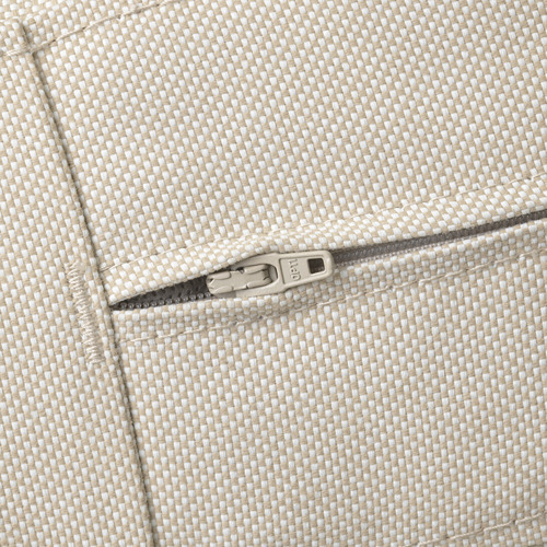 Primer plano de la cremallera sobre un cojín de exterior texturizado en color beige, que muestra calidad y durabilidad.