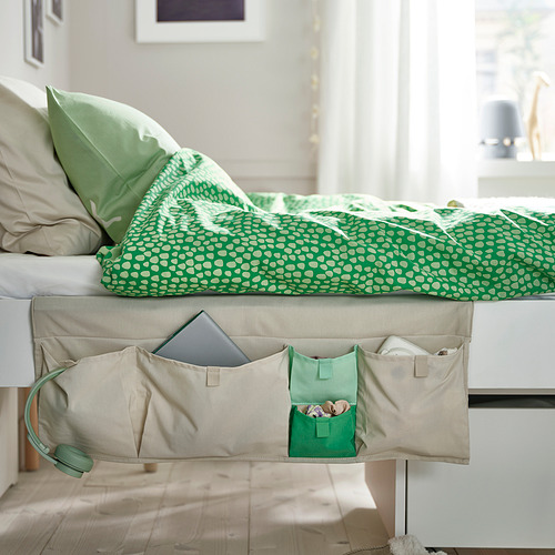 Colcha verde con almohadas y bolsillo de almacenamiento para niños.