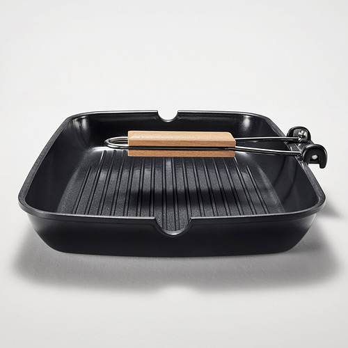Sartén para parrilla negra con mango de madera, superficie acanalada para asar uniformemente, ranuras para reducir la grasa, mango plegable para ahorrar espacio.