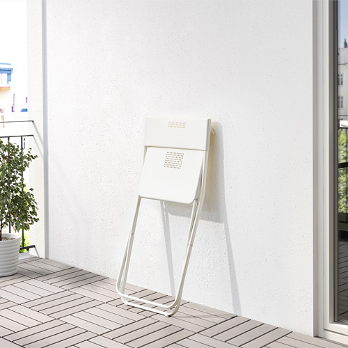 Silla blanca plegable en balcón alicatado, perfecta para espacios pequeños.