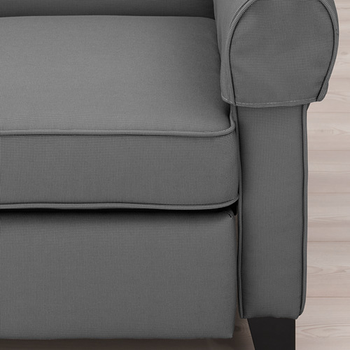 Primer plano de un cojín y reposabrazos de sillones tapizados grises. Tejido de alta calidad con diseño de brazo enrollado.