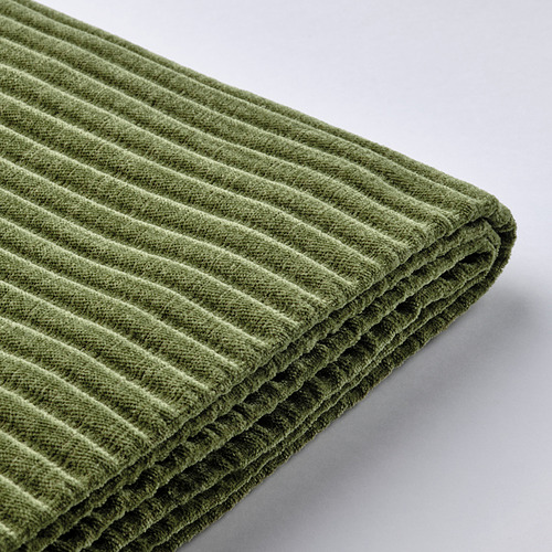 Un primer plano de una funda de sofá de tela acanalada verde de alta calidad, que destaca su textura y artesanía.