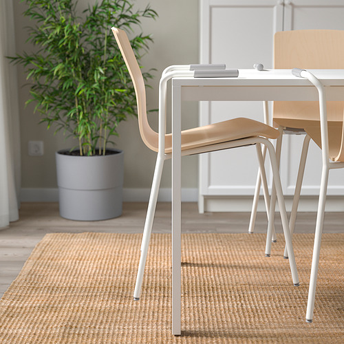 Moderna configuración de mesa de oficina con sillas LÄKTAR, con un diseño apilable y liviano y soporte lumbar para mayor comodidad en la postura.