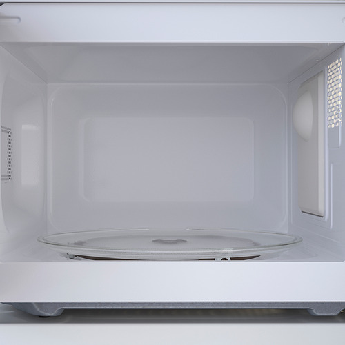 Interior de microondas vacío con plato giratorio de vidrio, listo para usar.