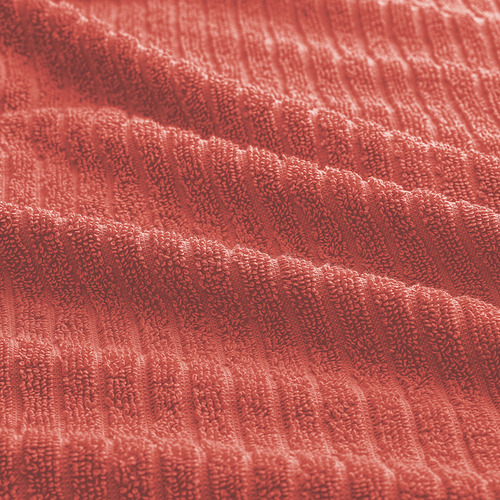 Toalla de color naranja vibrante con textura suave y absorbente. El tejido de rizo de grosor medio se siente acogedor contra la piel y se seca rápidamente.