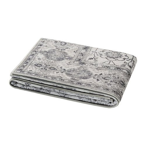 Folded grey LOKALTÅG blanket featuring intricate floral pattern, made from recycled polyester and synthetic rubber.