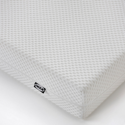 Representa un colchón de espuma blanca de alta calidad con una superficie texturizada y una etiqueta negra de ikea, lo que sugiere que es un producto de ikea.