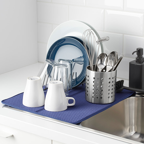 Organizador de fregadero de cocina: soporte de acero inoxidable para utensilios y platos de cerámica sobre tapete azul.