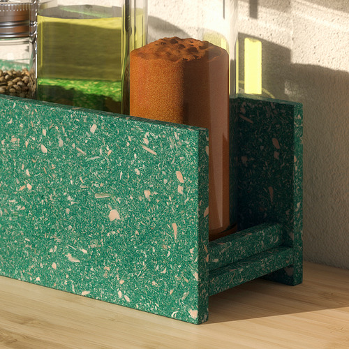 Estante de especias verde HUNDHAJ con diseño moteado, de pie sobre un piso de madera, sosteniendo frascos de vidrio con comida.