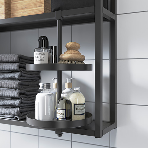Estante giratorio negro en el baño que contiene botellas, cepillos y toallas. Compatible con la serie Ehnet.