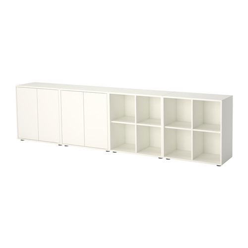 An EKET storage unit in white, featuring closed and open compartments for versatile organization. Modern and minimalist design with adjustable feet.