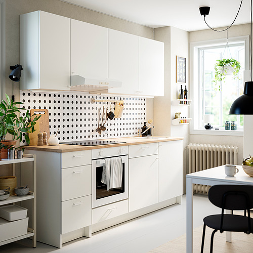 Cocina blanca KNOXHULT: diseño moderno con almacenamiento, gabinetes blancos, encimera de roble, placa para salpicaduras de lunares negros, diseño limpio.