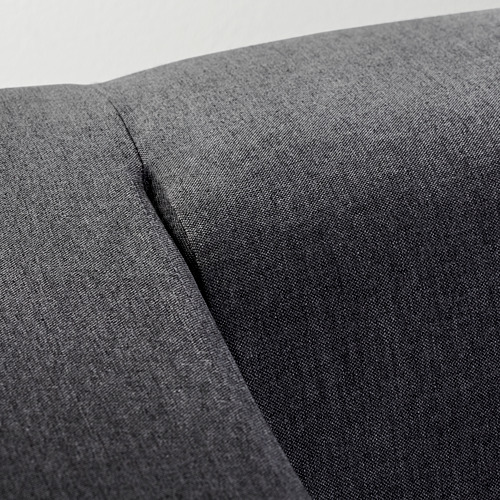 Primer plano: sofá moderno en tela gris oscuro, con una textura suave y costuras limpias.