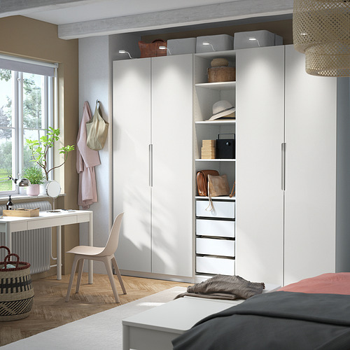 Dormitorio moderno con armario PAX blanco y silla colgante.