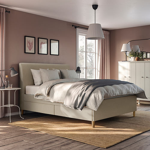 Cama IDANÄS en habitación neutra con estampados y cortinas transparentes.