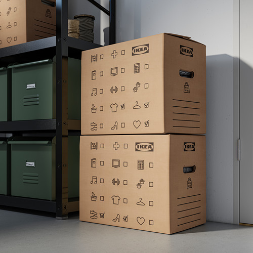 Dos cajas de almacenamiento de Ikea apiladas con símbolos cerca de estantes de metal.