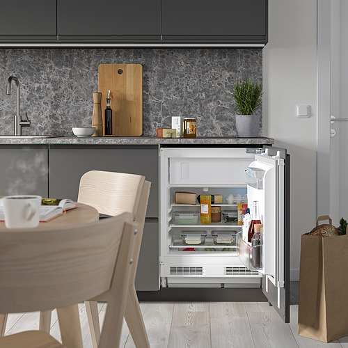 Cocina con nevera compacta abierta, estanterías iluminadas por leds.