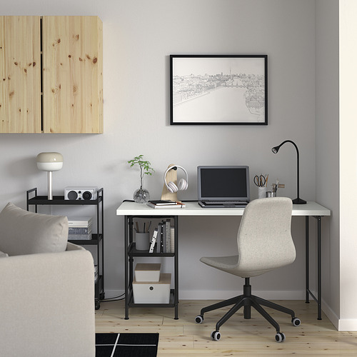 Oficina en casa con escritorio blanco, computadora portátil y silla gris. Decorado con una planta, una lámpara y arte mural. Ideal para trabajar/estudiar desde casa.