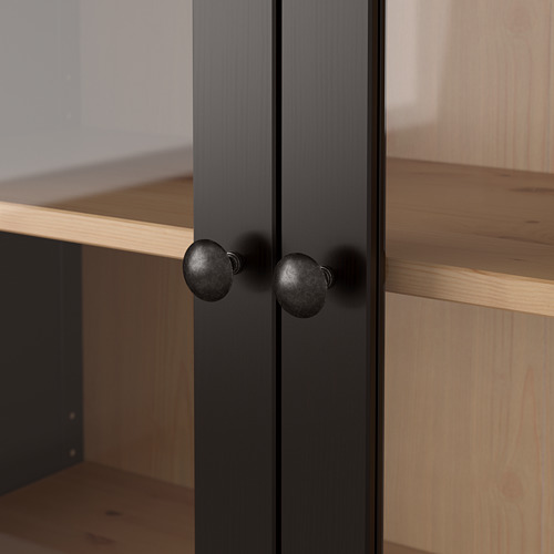 Mueble de madera oscura con pomos redondos negros, con bordes cuidadosamente acabados y un aspecto liso y pulido.