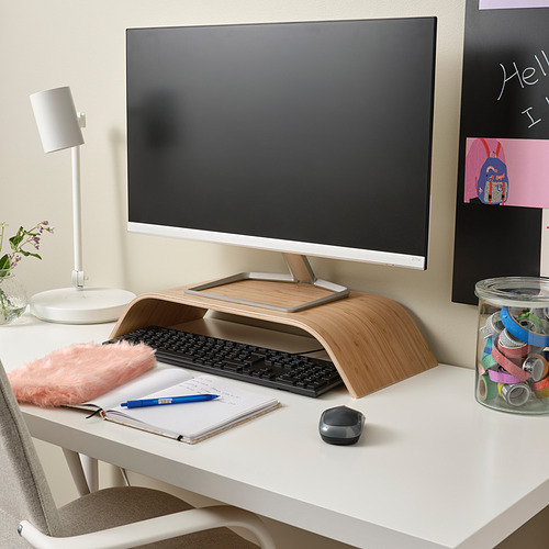 Oficina en casa con soporte de monitor de madera SIGFINN, teclado, ratón, lámpara sobre escritorio blanco.