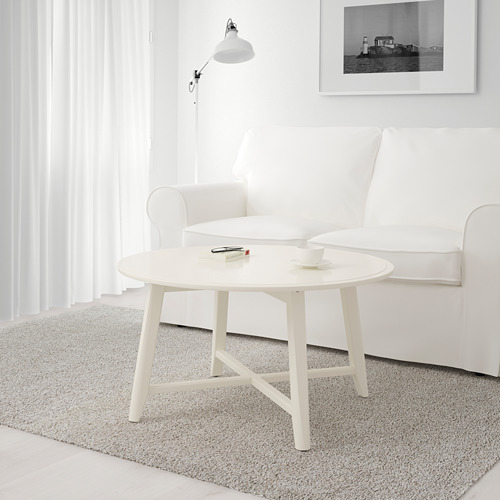 Mesita de centro blanca con tapa redonda y cuatro patas. Tiene capacidad para una taza y posavasos. Perfecto para espacios pequeños.
