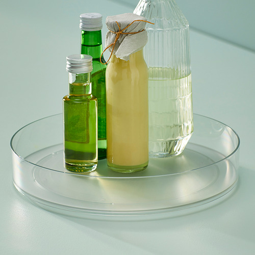 Plato giratorio de vidrio con tres botellas: aceite, jugo y agua. Se utiliza para el almacenamiento y acceso organizado de la cocina.