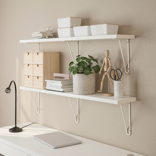 Estante de pared con soportes que sostienen contenedores, plantas y figuras de madera, con una lámpara y una computadora portátil en el escritorio debajo.