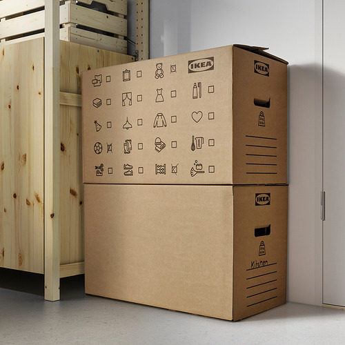 Cajas de ikea apiladas con iconos del hogar, DUNDERGUBBE, al lado del armario.