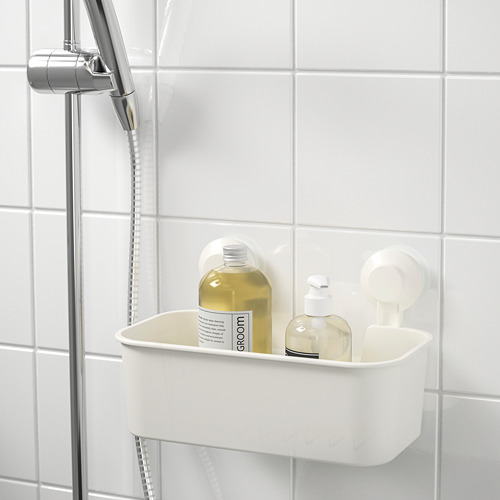 El carrito de baño blanco montado en la pared sostiene botellas de champú y jabón, usando ventosas en la pared de azulejos cerca del cabezal de la ducha.
