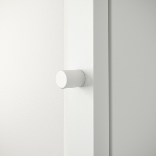 Tirador de puerta circular blanco sobre puerta blanca, diseño minimalista, acabado liso.