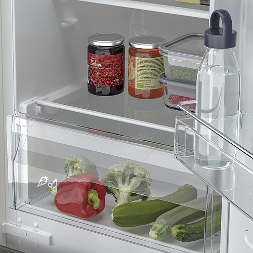 Nevera con estantes ajustables; verduras y frascos almacenados ordenadamente.