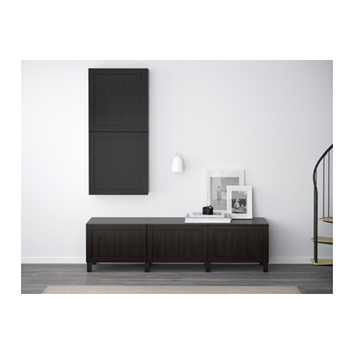 Minimalist room with BESTÅ sideboard, lights, photos, staircase.