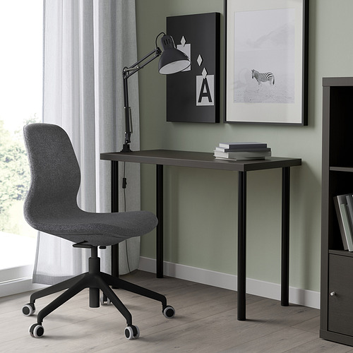 Modern home office setup with LINNMON black desk, grey chair, and minimalist decor. Desk is compact yet functional with adjustable legs.