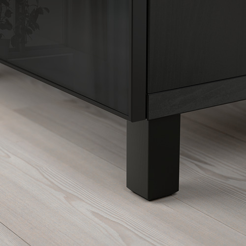 Modern, sleek black sideboard with glass top and wooden floor, showcasing quality design and materials.