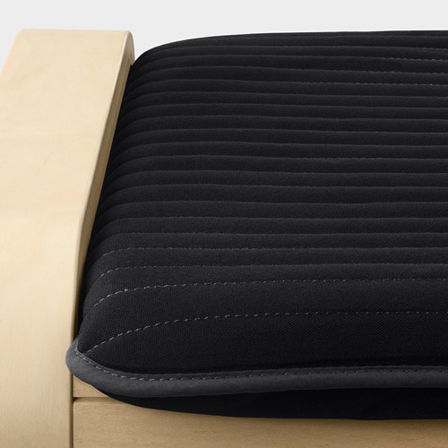 Asiento de sillón acolchado negro con estructura de madera. Detalle de costuras de calidad en tejido suave y liso.