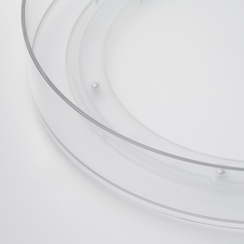 Organizador de almacenamiento circular transparente con bordes elevados, diseñado para una fácil rotación. Hecho de plástico duradero.