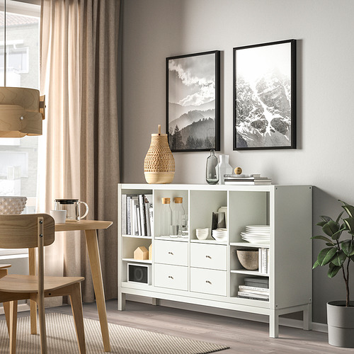 Almacenaje KALLAX blanco con estantes/cajones. Alto con estampado, planta y juego de comedor cerca.
