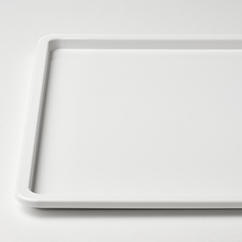 Bandeja rectangular blanca y limpia con bordes lisos, apoyada sobre una superficie.