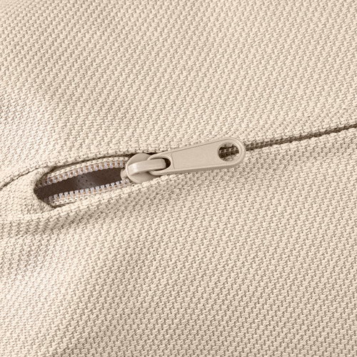 Detalle de cremallera de un tejido suave y texturizado. El primer plano muestra cremalleras, tirador metálico y dientes.