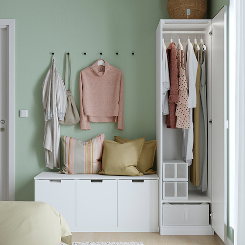 Dormitorio moderno con armario PAX, puertas abiertas que muestran ropa y almacenaje.