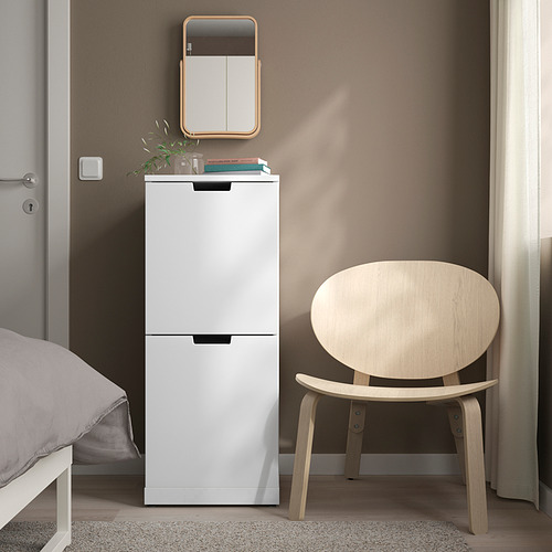 Cómoda de 2 cajones IKEA NORDLI blanca entre cama y silla, esquina minimalista.