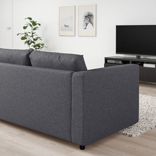 Moderno sofá modular VIMLE gris en salón minimalista con tv.