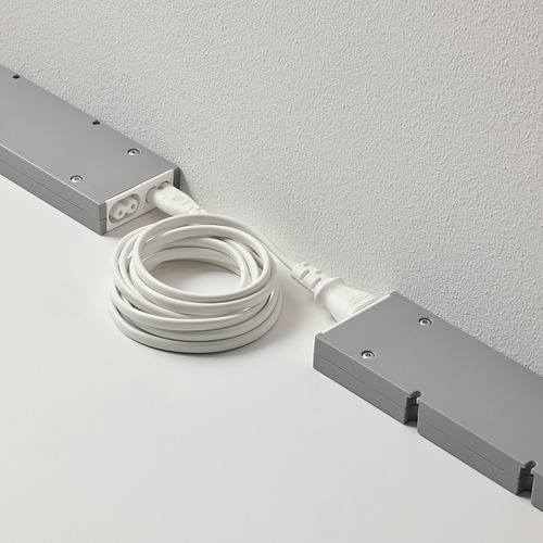 Dos dispositivos rectangulares conectados por un cable blanco para conectar y controlar varias lámparas con una sola fuente de alimentación.