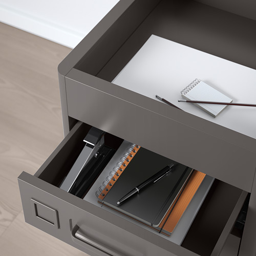 Cajonera de metal gris con bolígrafo, libreta y carpeta en el interior; Diseñado para uso en oficina con amortiguadores integrados para un cierre silencioso.
