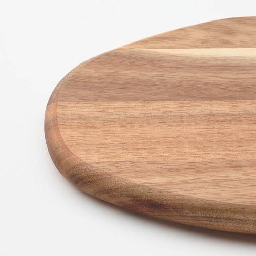 Tabla de cortar de madera, acacia suavemente pulida, veta natural visible, redonda con bordes curvos.