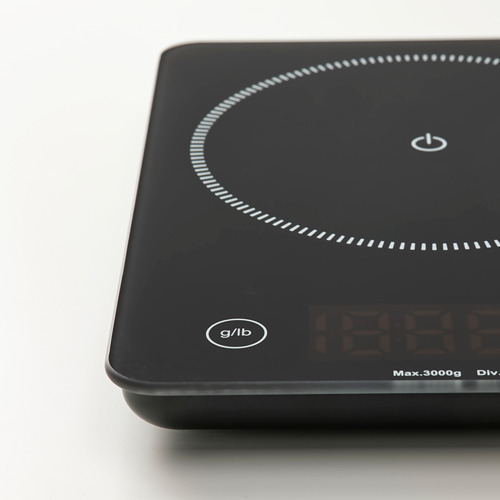 Báscula de cocina digital negra con tapa de vidrio, botón de encendido e indicador de peso, precisa para hornear.